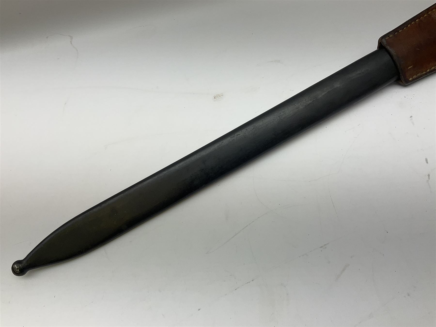 Swiss Schmidt-Rubin M1914 pioneer bayonet, with 48cm steel saw-back blade, the ricasso stamped, ''Waffenfabrik, Neuhausen'', the crosspiece stamped Swiss cross, steel scabbard, leather frog L64cm overall