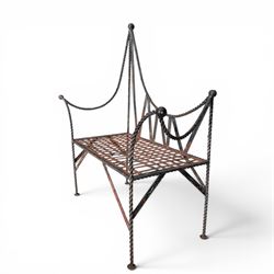 Victorian design wrought iron garden bench, with asymmetrical rope-twist frame, arched back and sides over out-swept arm terminals with ball finials, flanking a lattice seat, in antique black-painted weathered finish