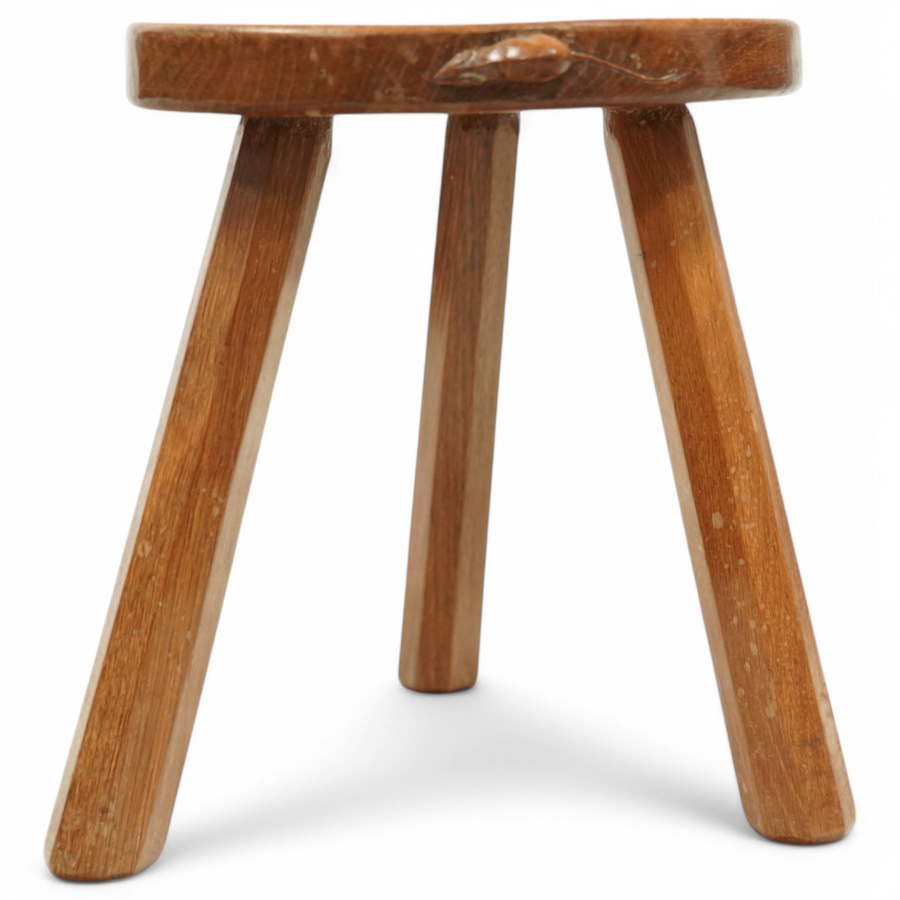 Mouseman - oak three-legged stool, dished kidney-shaped seat on three octagonal splayed supports, carved with mouse signature, by the workshop of Robert Thompson, Kilburn