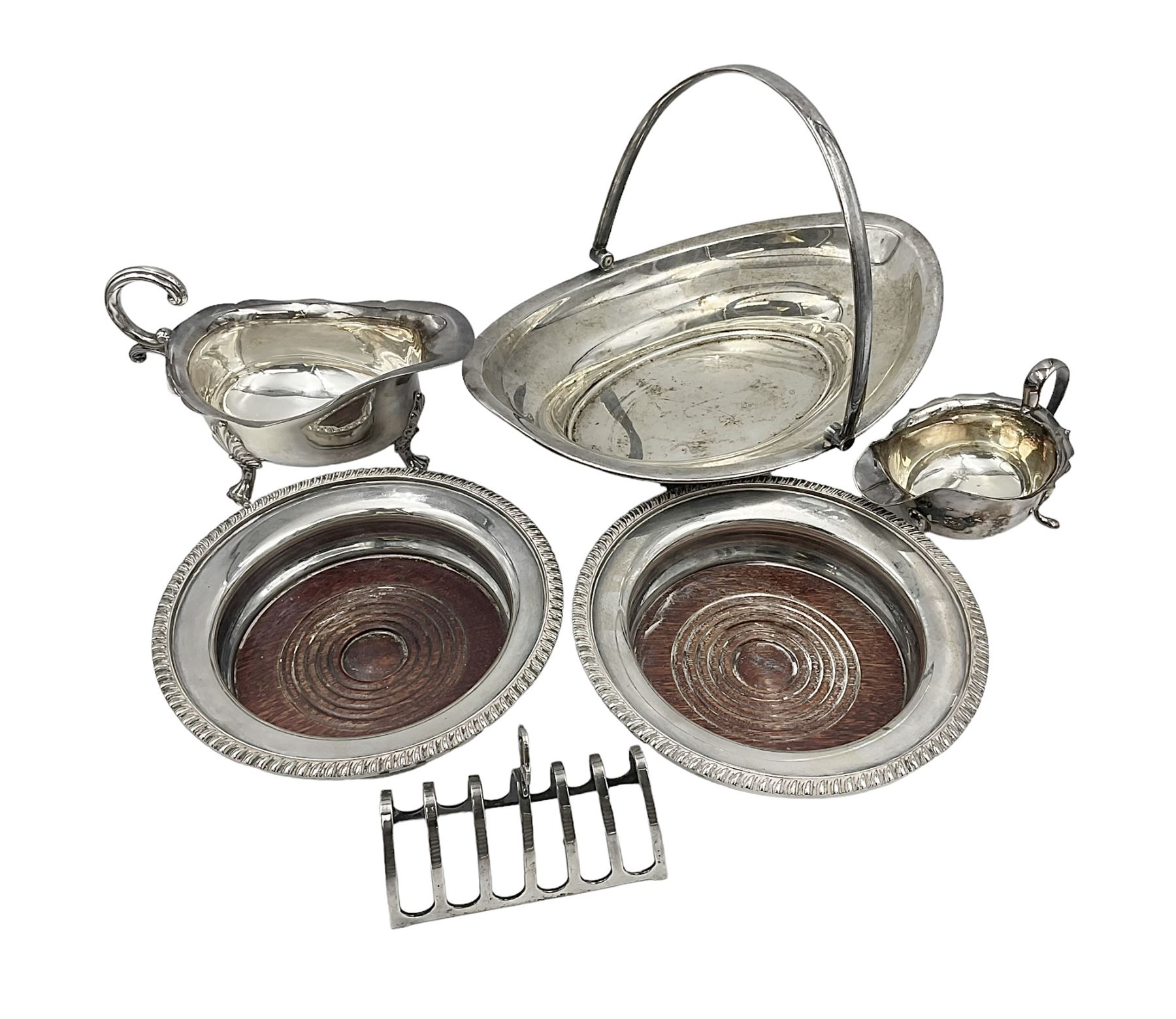 Silver plated seven bar toast rack by Mappin & Webb, together with other silver plated items including pair of bottle coasters, swing handled baskets and two sauce boats