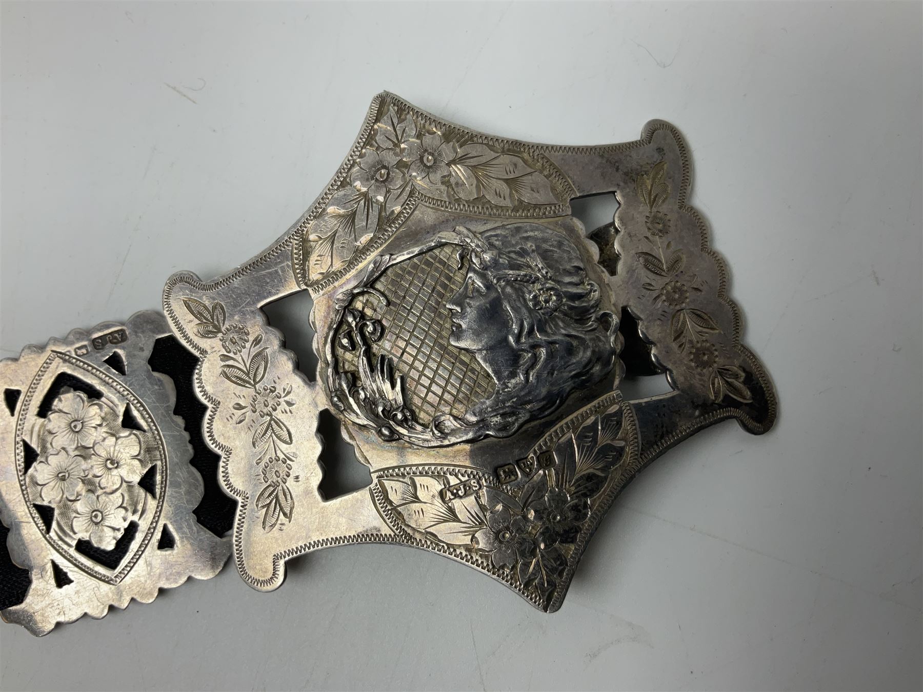 Art Nouveau silver belt, with two buckles, each depicting a female figure in profile and twelve engraved floral openwork panels, hallmarked Arthur Johnson Smith, Chester 1907, L60cm