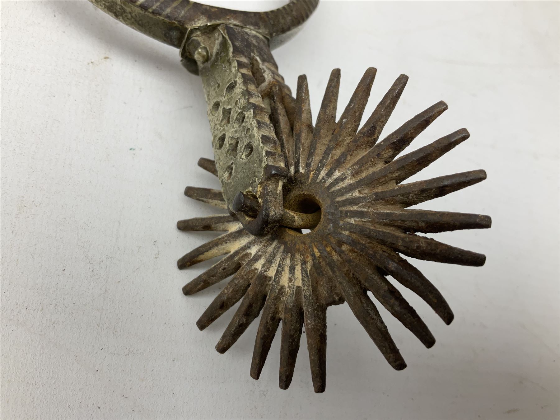 Pair of late 19th century South American iron spurs, engraved silver mounts, with sunburst rowls