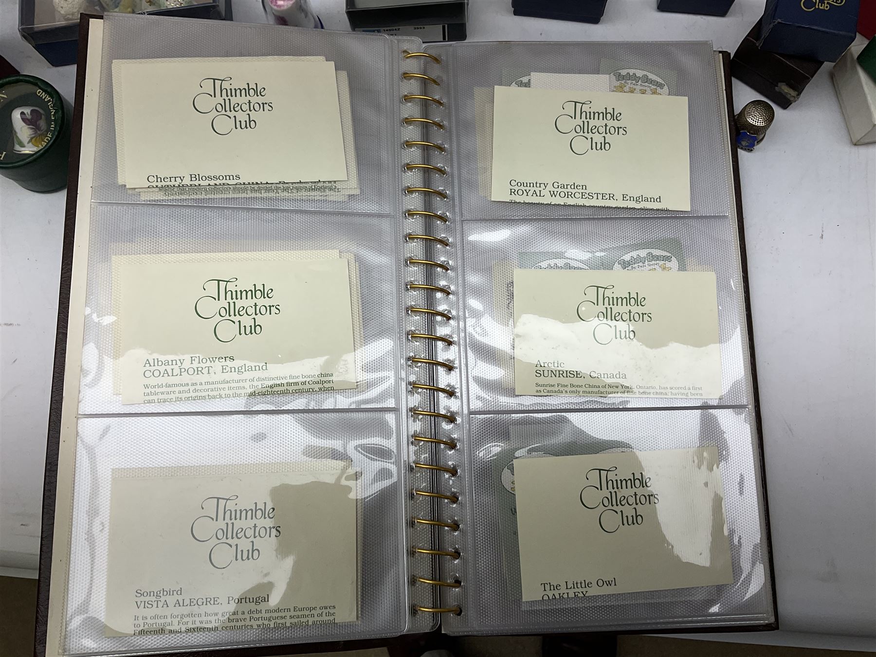 Quantity of thimbles to include twelve Irish Dresden lace examples, Royal Crown Derby, Spode, Portmeirion, Wedgwood, Royal Grafton etc, together with three display cases, many with certificates