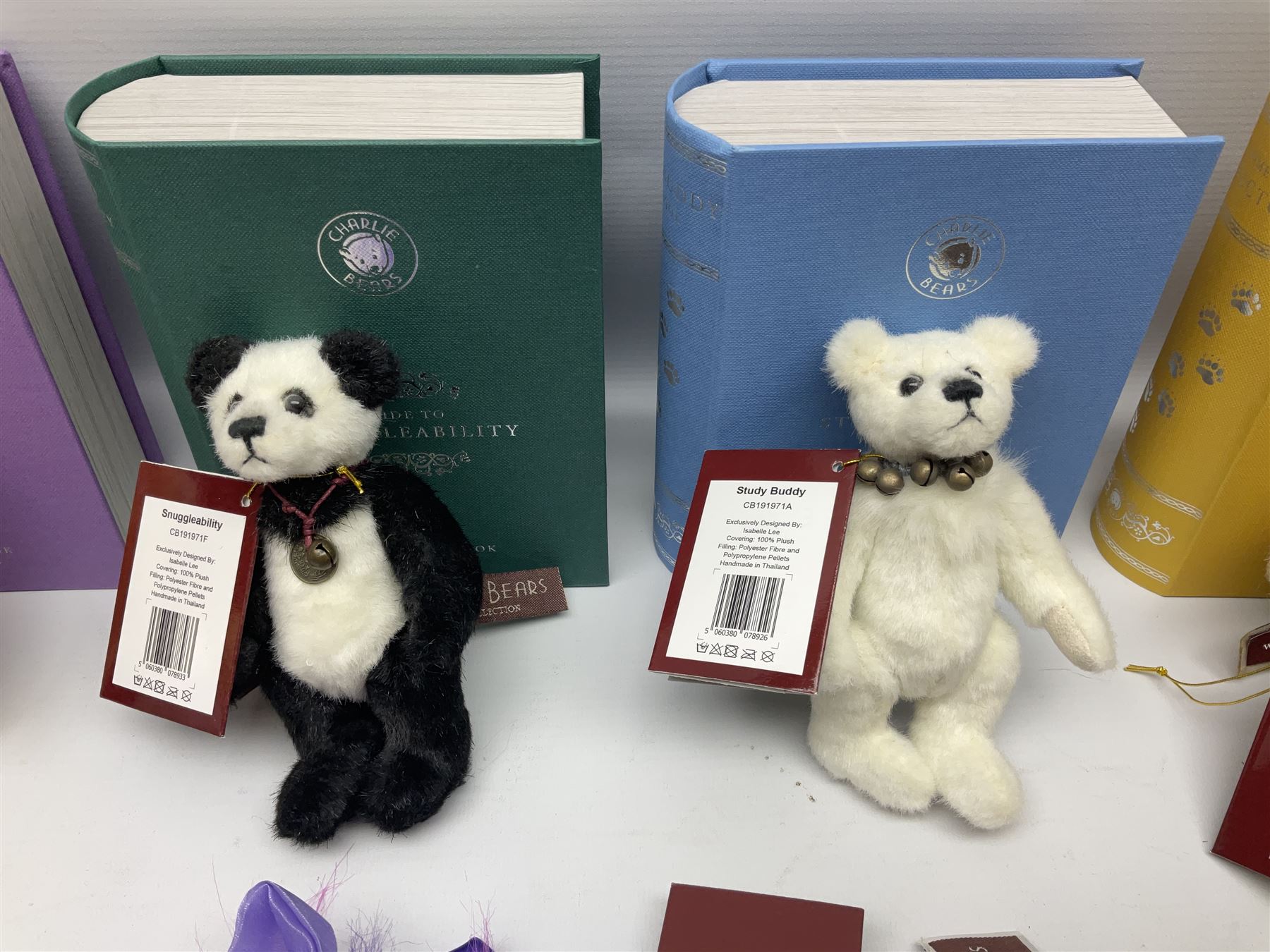 Five Charlie Bears Plush Hug Book Collection books, comprising Guide To Snuggleability containing Snuggleability CB191971F, Paw-Some Facts Directory containing Pawsome CB191971D, Bear Therapy Handbook containing Bear Therapy CB191971E, Study Buddy Handbook containing Study Buddy CB191971A, and Guide to Being Bear-illiant CB191971B, each designed by Isabelle Lee, each with tags, plus Charlie Bears Secret Hug Book (lacking contents), together with assorted Charlie Bear accessories, to include two Bear Ears Duffle headbands CBBEARSDUF, Egg Cup CB185198 , Incy Wincy CB205252AO, with tag, four key rings, all with tags, Bear Care Kit and contents, recipe cards, pin badges, tape measure, notebook, etc., (Qty)