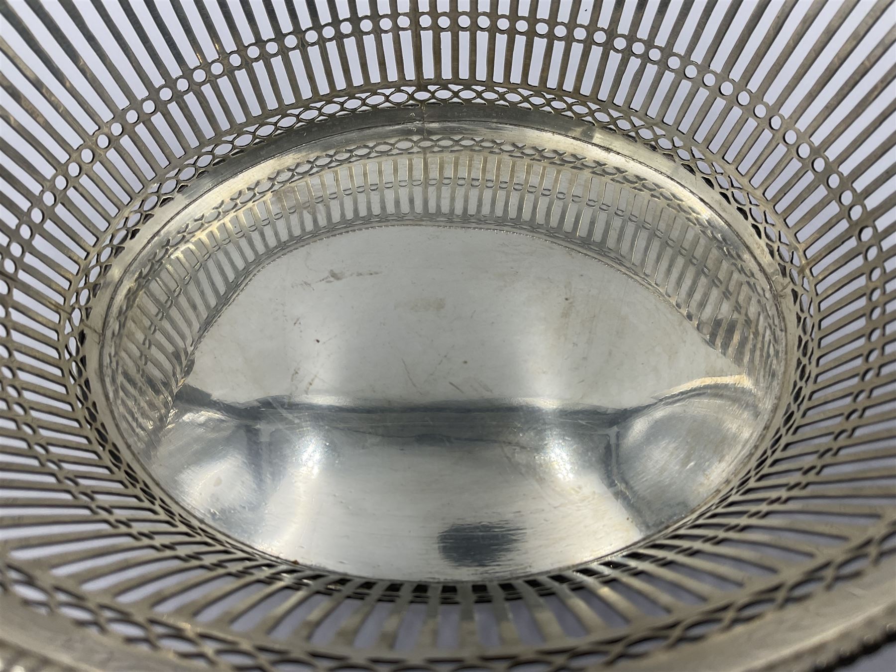 Early 20th century Dutch silver basket, of oval form with pierced sides, beaded rim, and twin handles, marked with Lion Passant for 2nd standard purity and date letter for 1910, other marks worn and indistinct, including handles H8.5cm L25.5cm