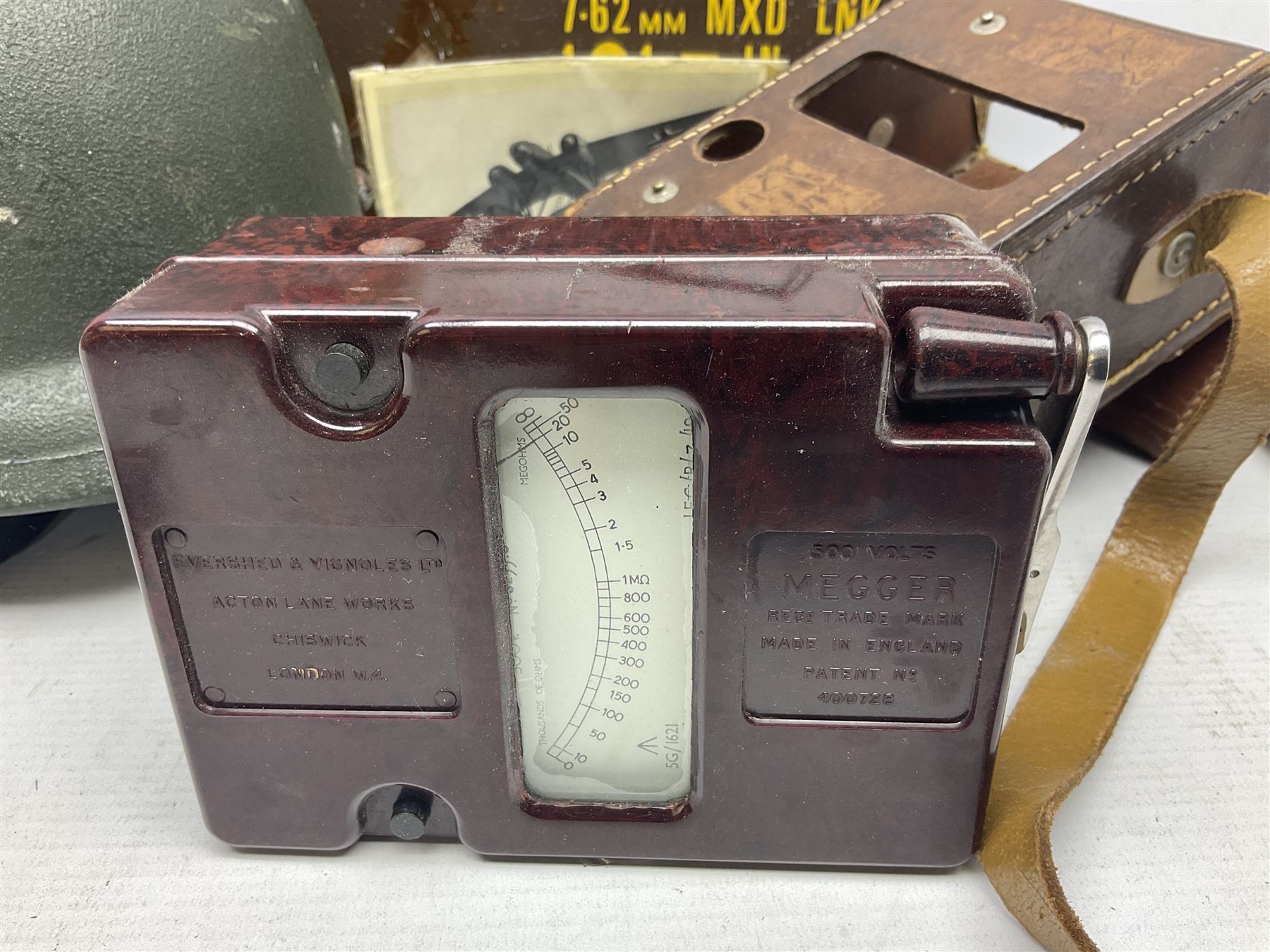 Bakelite cased Megger Insulation tester, by Evershed and Vignoles Ltd, Acton Lane Works, Chiswick, London W4, RW Munro Ltd air speed knots gauge, American green army helmet, The War Illustrated, WW2 aircraft photographic postcards, etc