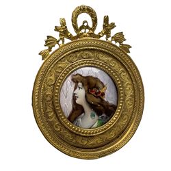 Late 19th/early 20th century Limoges enamel plaque, circa 1900, painted with a portrait of Anette after Grasset, in circular gilt metal frame with foliate border and ribbon surmount, easel style support verso, H9cm