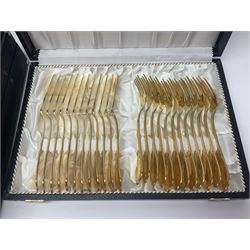 Bestecke Solingen canteen of gold plated cutlery for twelve place settings, including ladle, cake slice and serving spoons, contained within a briefcase, together with a matching set twelve of Bestecke Solingen gold plated fish knives and forks, in fitted case 