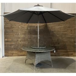 LeisureGrow circular rattan garden table, with lazy Susan, five armchairs with cushions, parasol and weighted base, with glass tops