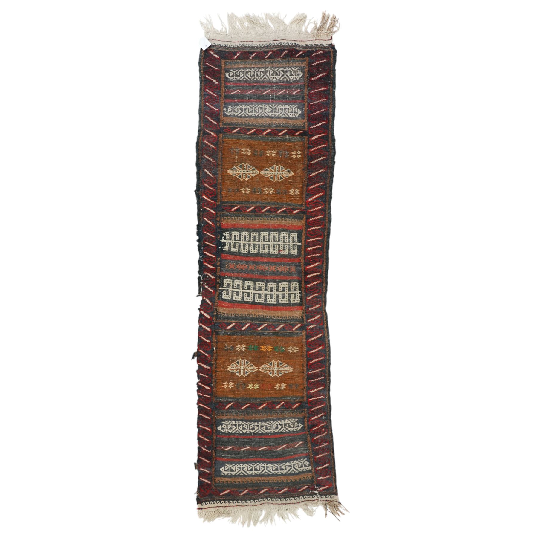 Group of four late 20th century wool kilim rugs, comprising a narrow tribal runner with stylised tree motifs and hooked guard bands (H 180cm, W 56cm), a lozenge medallion rug with decorative striped ends (H 125cm, W 75cm), a red and blue kilim with trefoil repeat field and multicoloured border bands (H 187cm, W 98cm), and a wide horizontal striped example with alternating lozenge and linear motif rows (H 260cm, W 173cm)