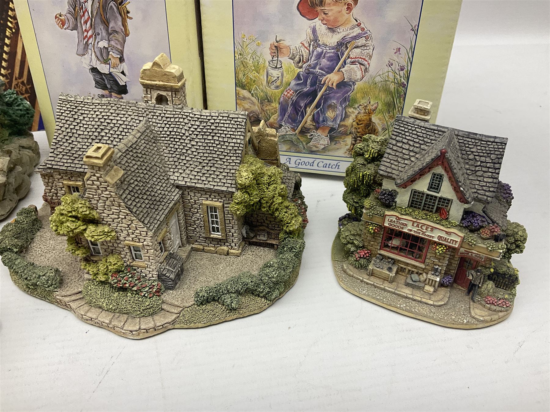 Twenty three Lilliput Lanes, including Village School, Lace's Shoe Shop, Cockles & Muscles, Scotland the Brave etc, together with The Leonardo Collection Paint Box Poppets and Gullivers World magazines 