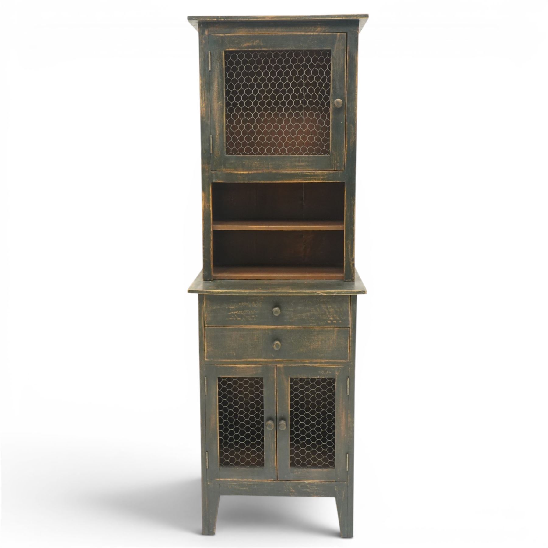 20th century pine kitchen cabinet in a green painted finish, top section with upper door with wire front above a recessed shelved area, the lower section with two drawers and twin wire fronted doors, raised on tapered supports