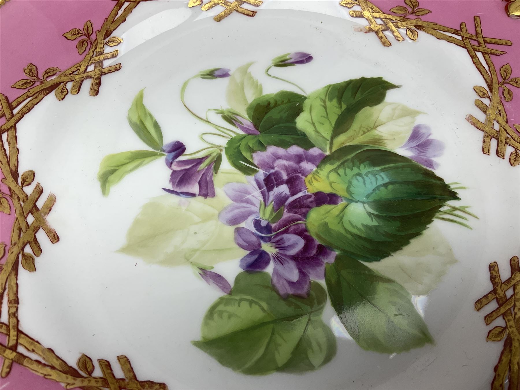 Victorian dessert service, comprising four comports and nine plates, each decorated with floral sprigs to the centre with a pink and gilt border, largest comport H13cm, plate D22.5cm