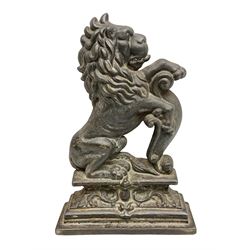 Cast iron door stop, in the form of a rampant lion on elaborate stepped plinth base, H38cm