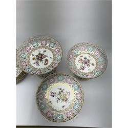 A Dresden dessert service, comprising six comports and nine plates, with pierced rims, and decorated with floral sprays and sprigs and heightened in gilt, tallest comports H20.5cm, plates D22cm.