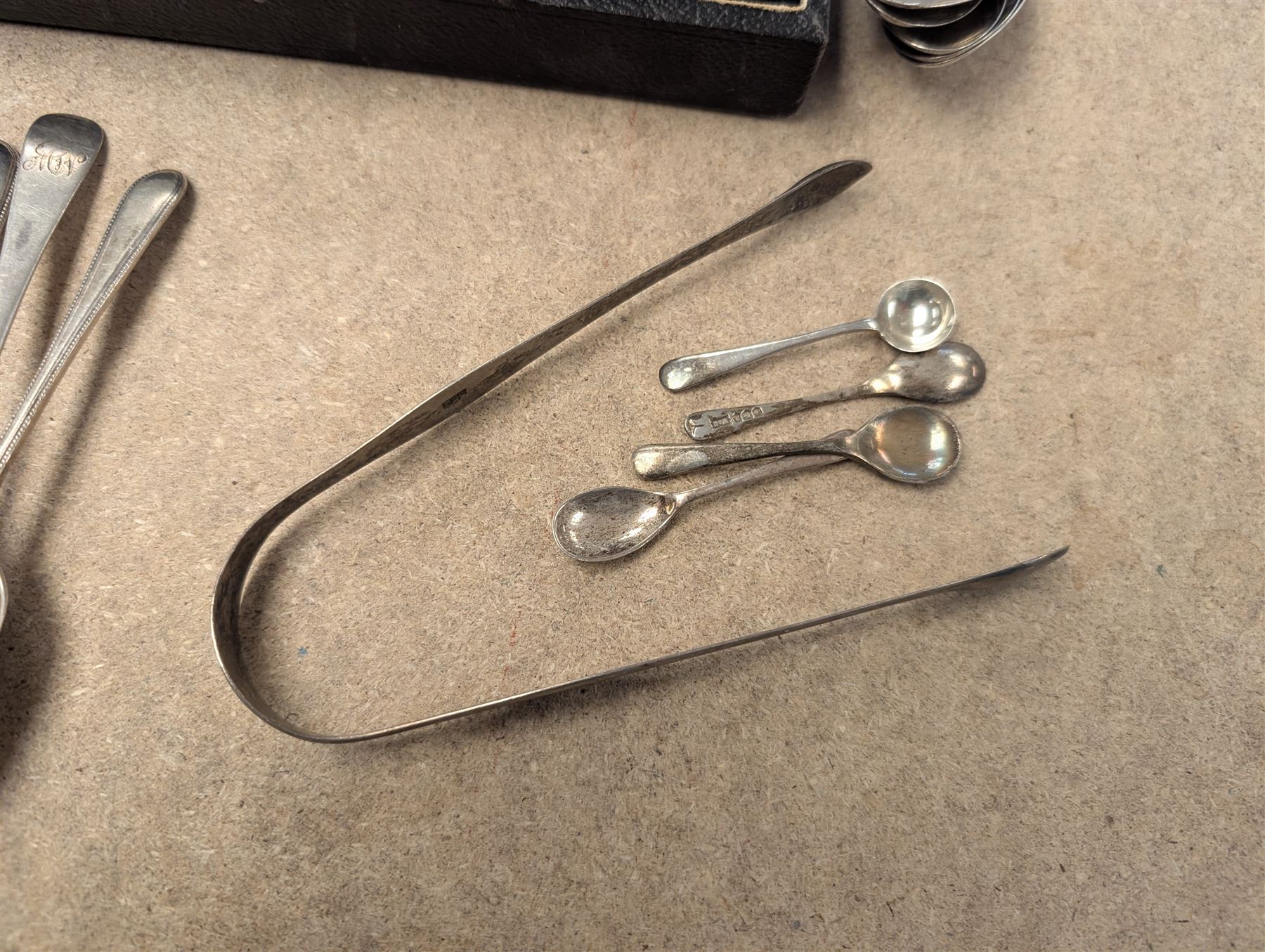 Group of silver, comprising mustard pots, open salts, napkin ring, spoons, sugar tongs and fruit knife, all stamped or hallmarked 