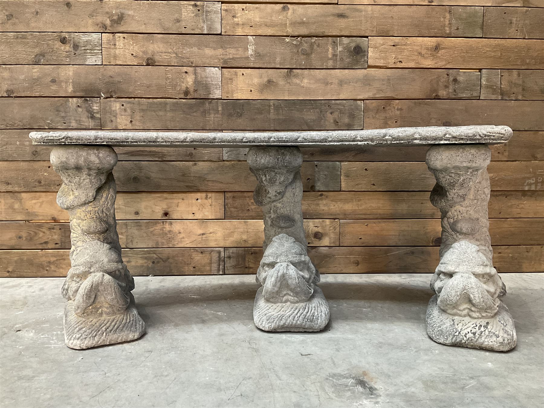 Cast stone four piece curved Dolphin bench, set with three dolphin pillars, curved rectangular slab top with detailed border