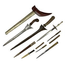 Malayan Kris dagger, the 31.5cm double edged straight heavy damascus blade with copper ferrule; carved hardwood grip; in large wooden throated scabbard with floral decorated white metal covering L47.5cm overall; a kris blade with adapted antler grip; and five various small daggers/letter openers (7)