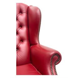 Kingsgate - contemporary 'Queen Anne' wingback armchair with matching stool, high back with deep button tufting, upholstered in red leather with brass stud trim, on carved cabriole supports