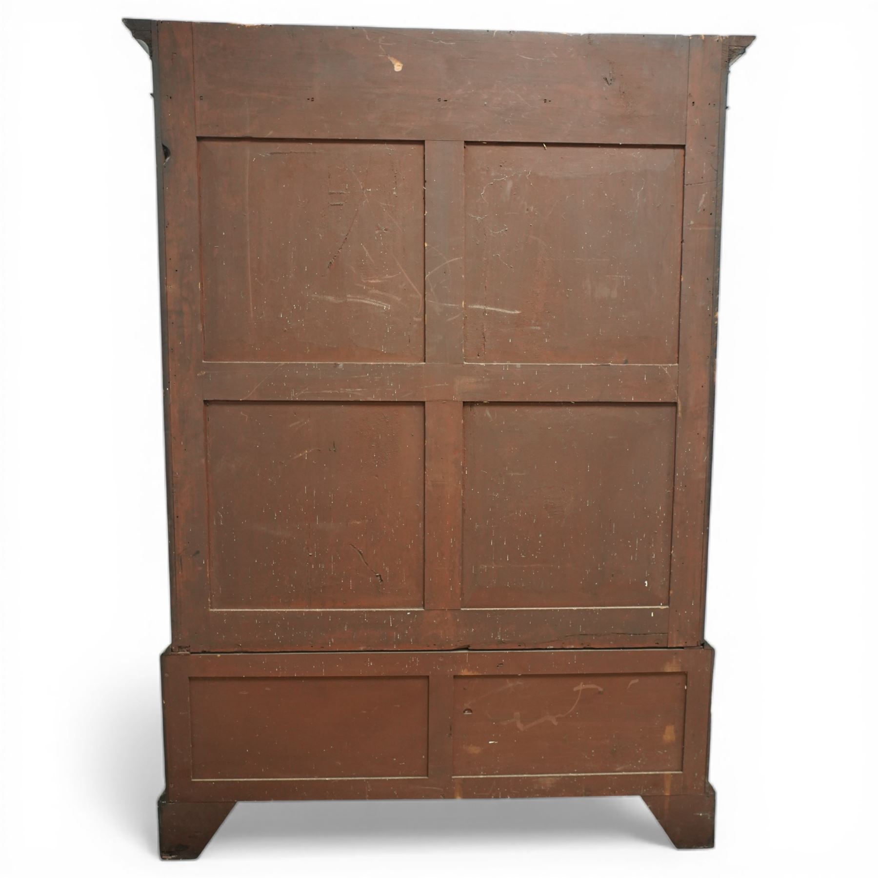 Early 20th century mahogany glazed bookcase, the moulded cornice above a carved frieze with interlaced ornament, enclosed by a pair of astragal glazed doors with geometric glazing bars, the base fitted with two short over two long drawers with brass swan neck handles, raised on bracket feet