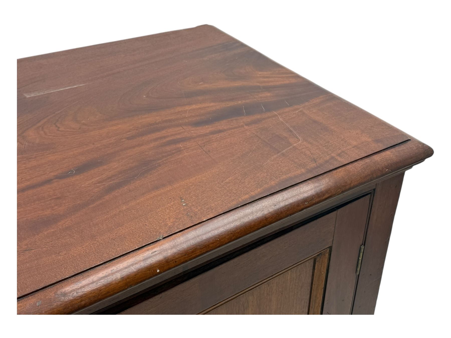 Victorian mahogany cupboard, plain rectangular top above two fielded panel doors opening to shelved interior, raised on a moulded plinth base, with later replacement knob handles