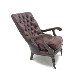  Chesterfield style library armchair, upholstered in deep buttoned ox blood leather, turned supports, brass castors, W60cm  