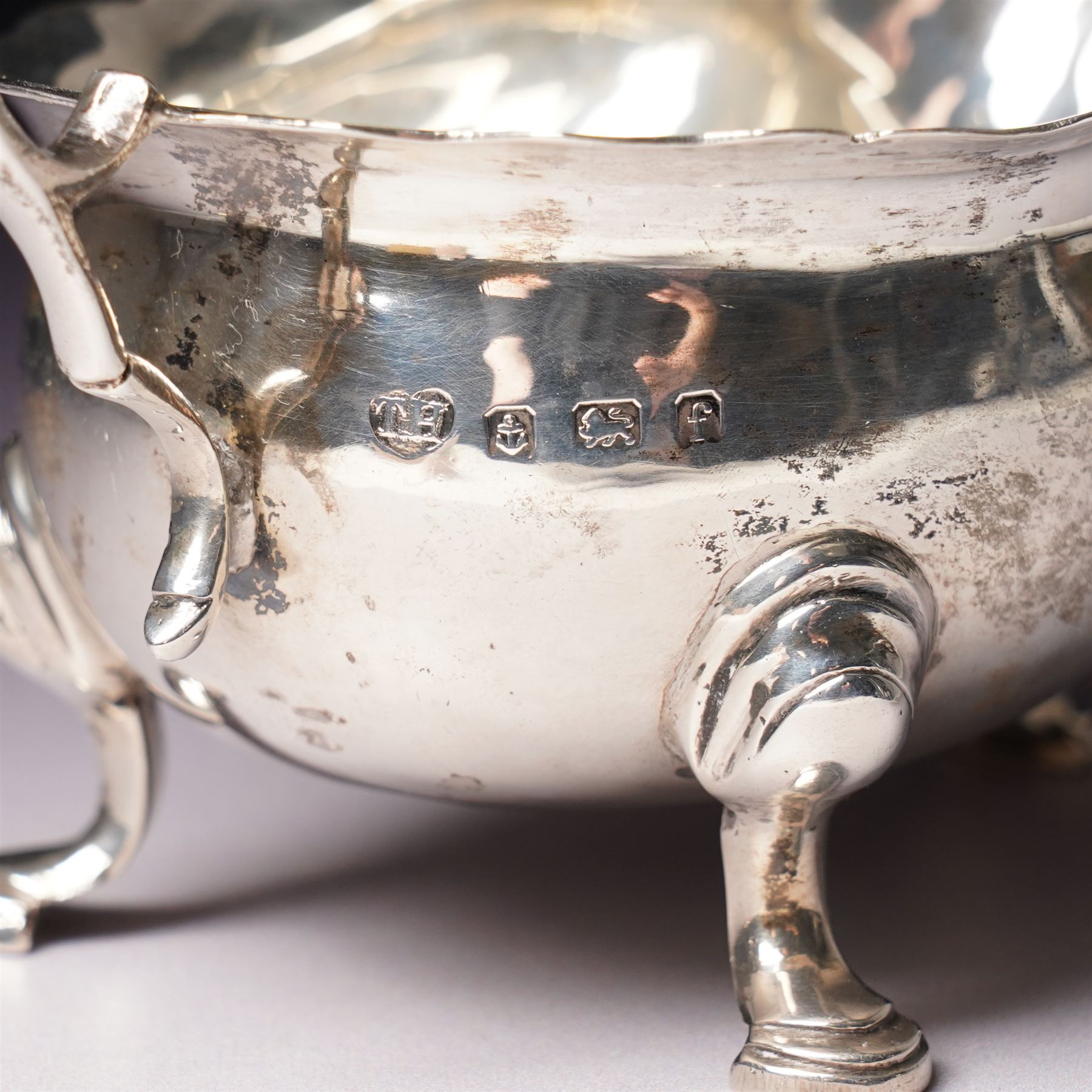 Pair of Victorian silver grape scissors with engraved decoration Birmingham 1860 Maker probably John Gilbert and a small silver sauce boat with crimped rim and C scroll handle Birmingham 1905 Maker Thomas Hayes (2)  