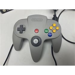 Nintendo 64 console, two controllers, games and accessories. Accessories to include the ‘Tremorpak’ and ‘Spook’ 2 Phono plugs and a S-VHS plug with adapter, both in original boxes. Games to include ‘Golden Eye 007’, ‘Doom 64’, ‘Killer Instinct Gold’, ‘Tetrisphere’, ‘F-1 World Grand Prix’, ‘Pilotwings 64’ and ‘Lylatwars’ with ‘Rumble Pak’, all with original boxes and instruction manuals. ‘Star Wars Episode I Racer’ game cartridge in Shadows of the Empire box. 