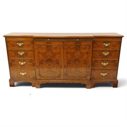 Georgian design figured and burr walnut breakfront sideboard, shaped rectangular top inlaid with crossbanding and stringing, fitted with central brushing slide over cupboard enclosing single adjustable shelf, flanked four graduating cock-beaded drawers to each side, raised on bracket feet