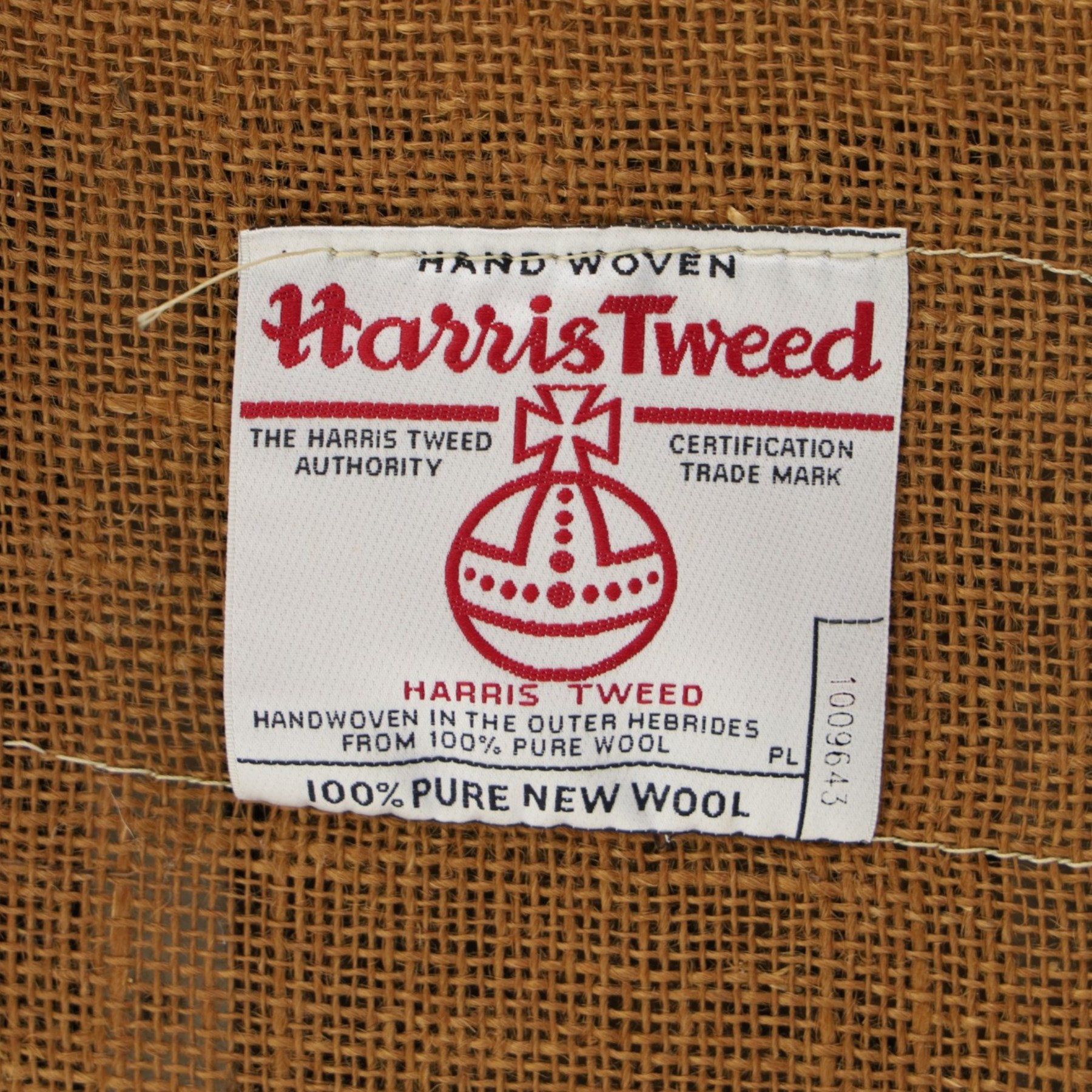 Tetrad - 'Taransay' Harris Tweed and tan leather club armchair, Howard shape with reclined back over deep seat and rolled arms with studwork, raised on turned front supports with castors, the sides and arms upholstered in tan leather with seat and back in herringbone-stitched Harris Tweed