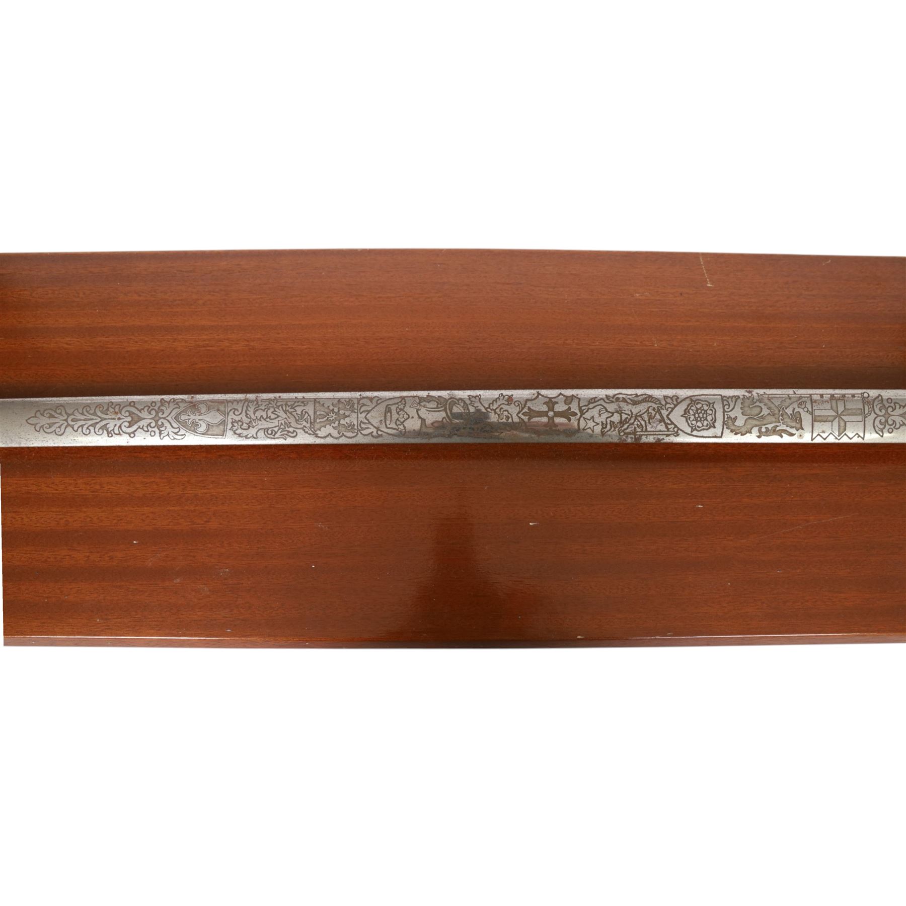 Wilkinson Sword, with 76cm double edge blade, etched with makers name and decoration, wooden grip, brass guard and hilt, together with another sword