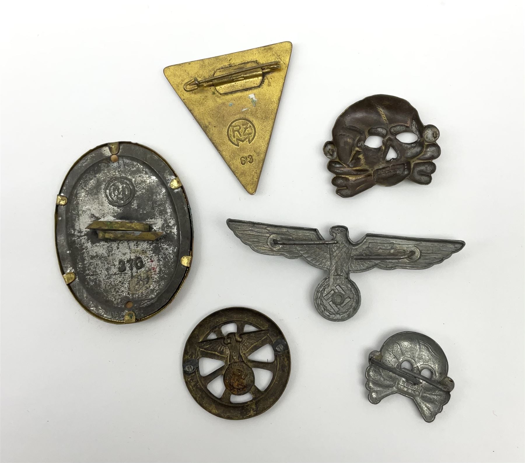 Six WW2 German badges - cap badge D.A.F. labour front; SS skull cap insignia First pattern 1925-35; Frauenschen Mother's Union; tank driver collar badge 1939-42; N.S.K.K. cycle corps; and officer's cap insignia 1940-42 (6)