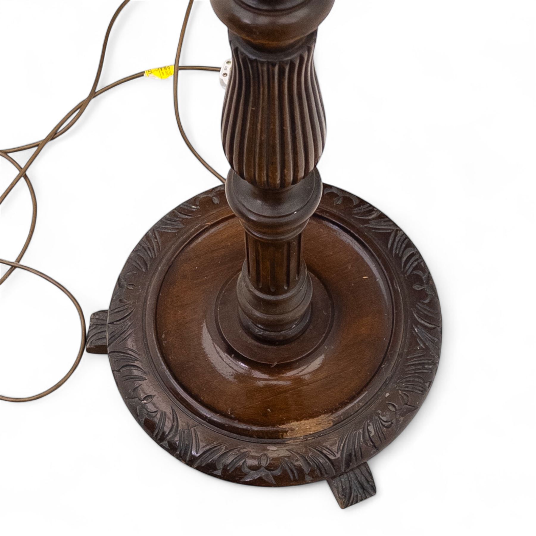 20th century mahogany floor lamp, the reeded column with carved urn knop on circular foliate moulded base, with cream fabric shade