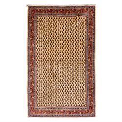 West Persian Boteh-Mir hand-knotted rug, ivory field densely decorated with a repeating la...