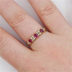 18ct gold three stone round cut ruby and round brilliant cut diamond ring, London 1991