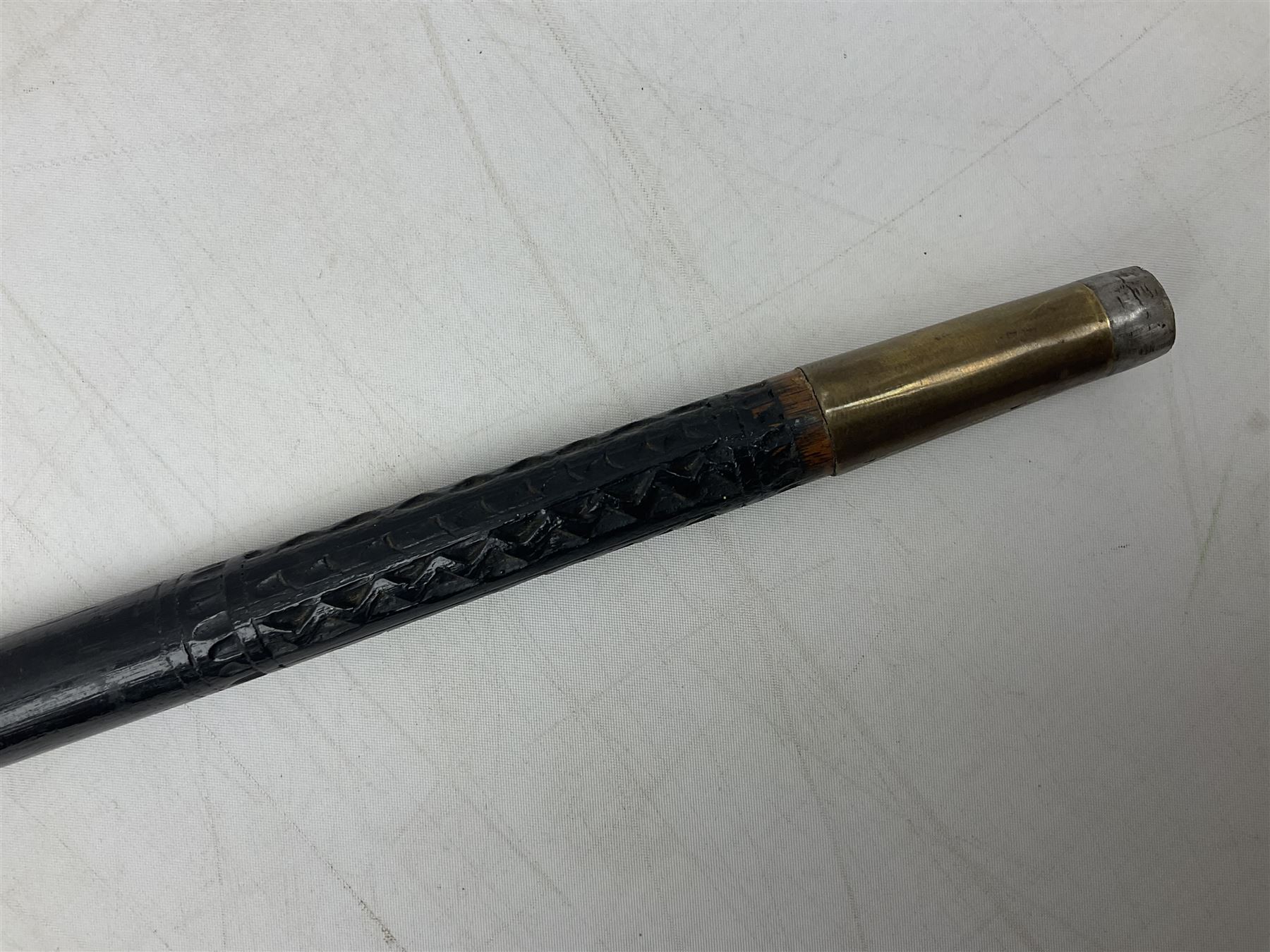 Late 19th/early 20th century Anglo Indian ebony and bone sword stick with 62cm steel blade, brass locking ferrule and lion mask pommel L92 cm.