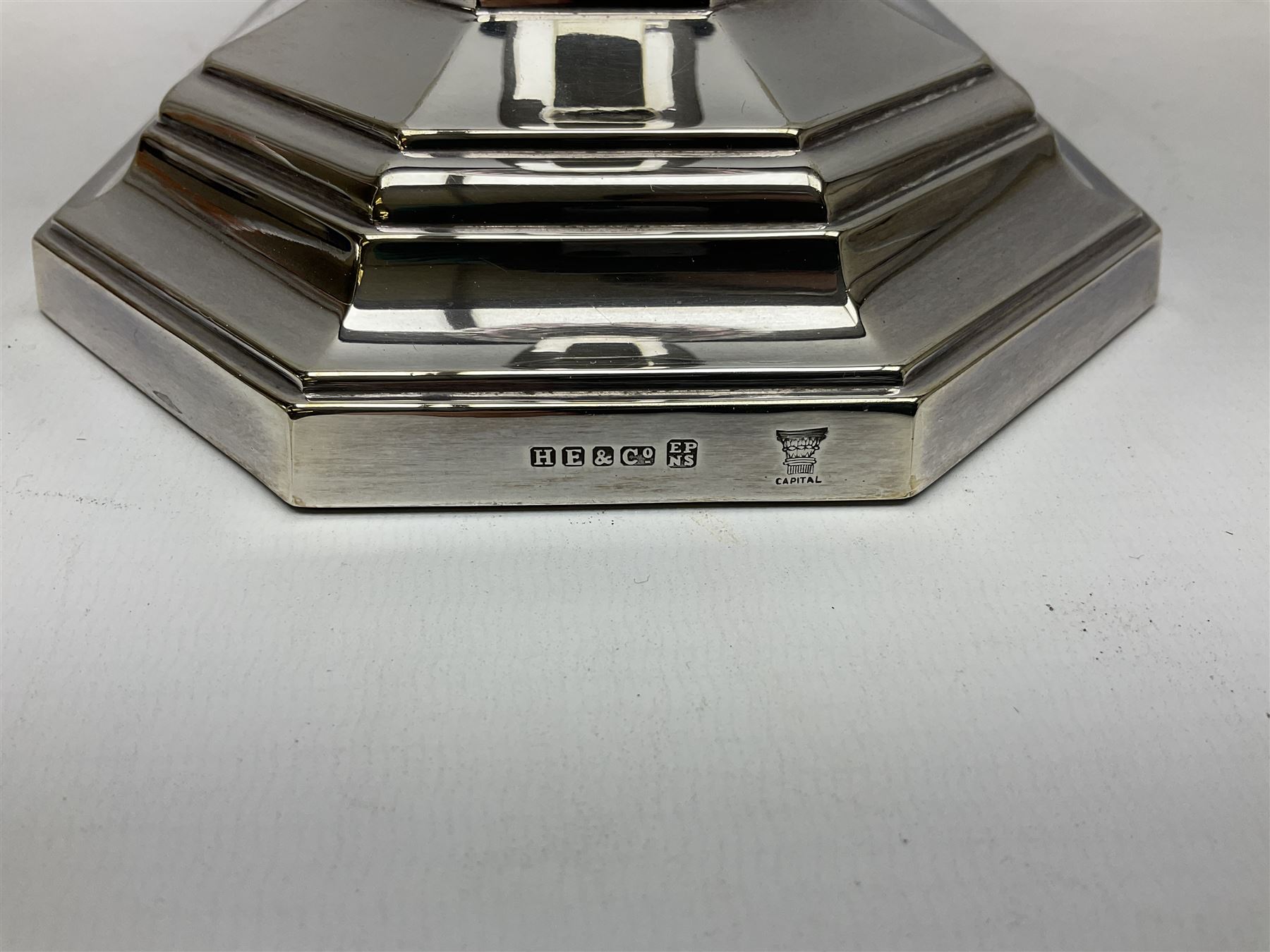 20th century Hawksworth, Eyre & Co silver plated oil lamp, the octagonal stepped base with engraved dedication, leading to an octagonal column supporting a faceted clear glass reservoir, Hinks Duplex burner, clear glass chimney, and cranberry glass shade, overall H71.5cm