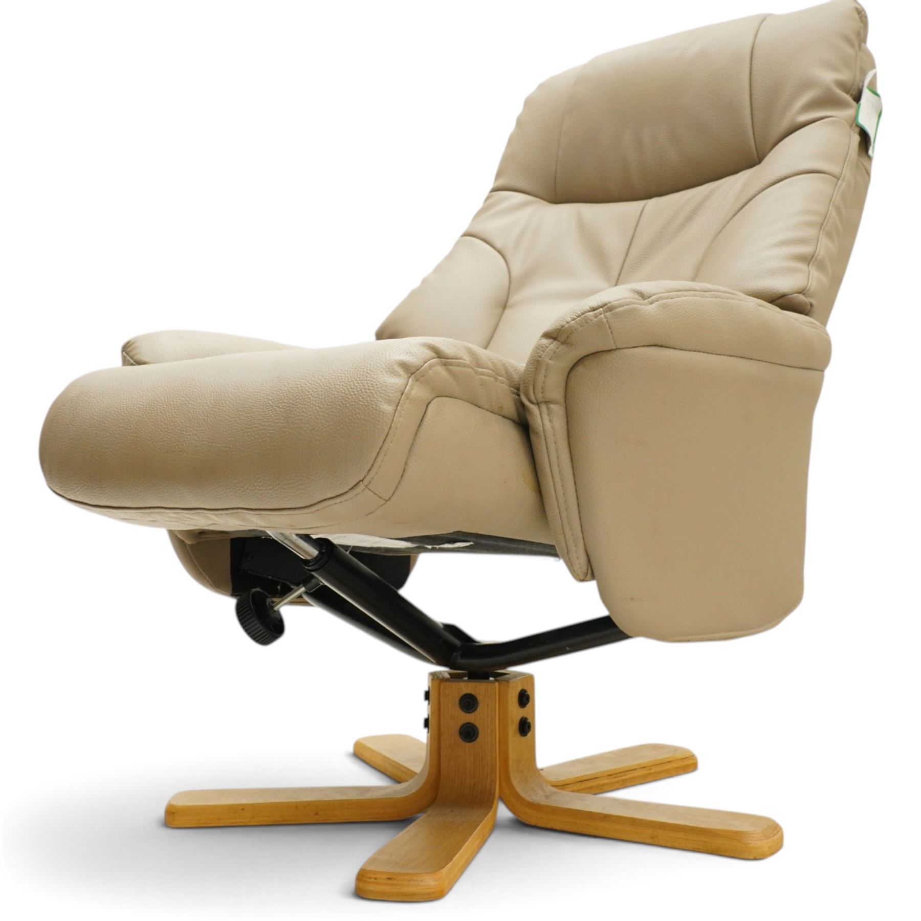 Modern beige leather upholstered swivel armchair and matching footstool, the high back and padded arms with stitched panel detail, raised on laminated beech five and four star bases