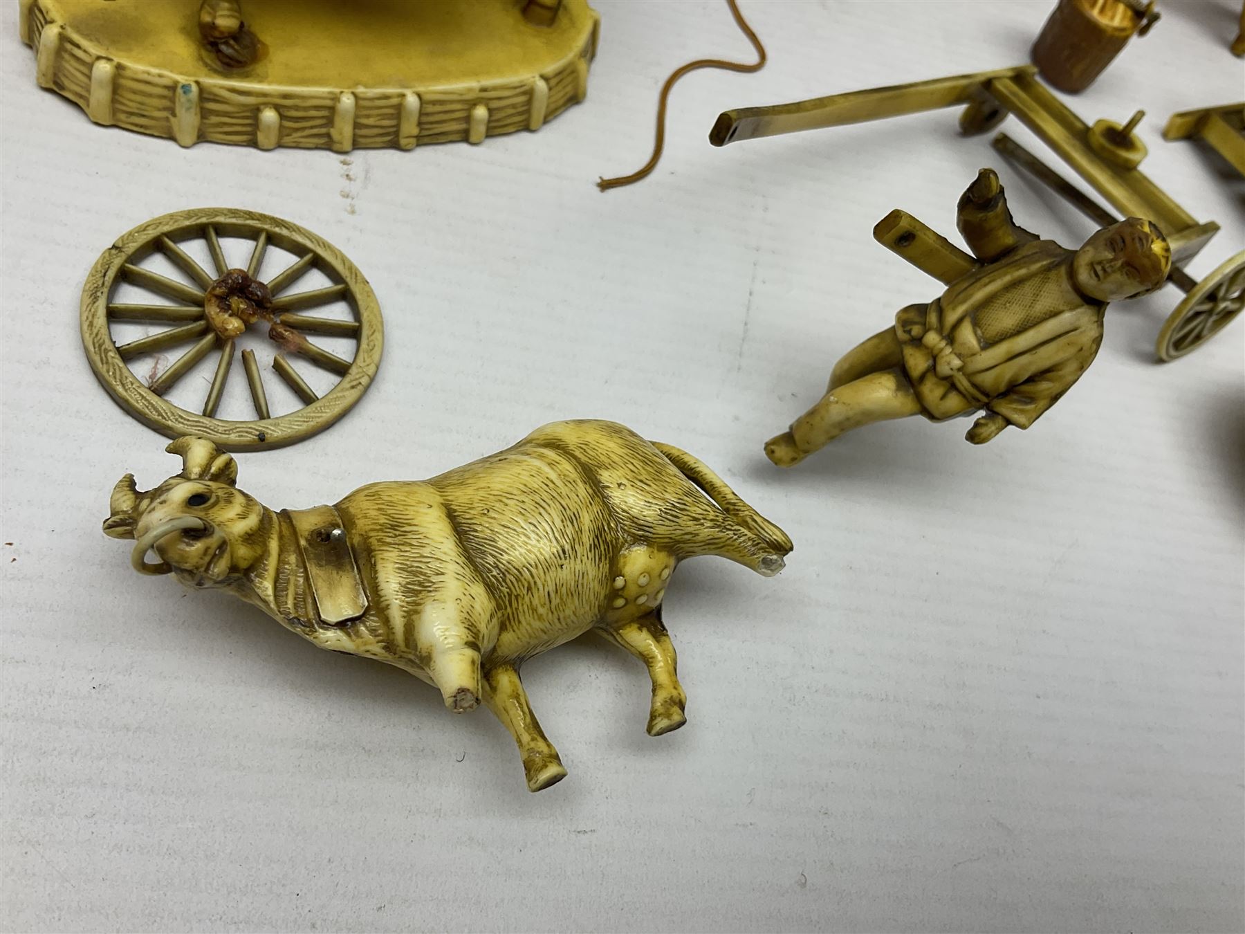 Collection of Japanese celluloid figures, including Rickshaw groups, fishing scene, oxen etc 