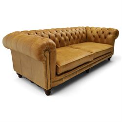 Distinctive Chesterfields - traditional shape four seater Chesterfield sofa, the rolled back and arms upholstered in deep-buttoned tan leather with matching loose seat cushions, raised on six turned supprorts