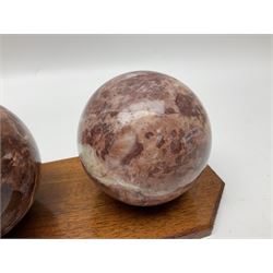 Set of three marble spheres on a elongated octagonal wooden base, H12cm
