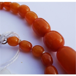  Single strand amber bead necklace, with gold clasp stamped 9ct  