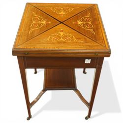 Edwardian inlaid mahogany envelope table, square top with triangular leaves revealing a baized lined interior and wells, raised on tapering supports united by an under tier, terminating in brass castors
