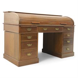 Edwardian oak roll-top desk, the tambour enclosing a fitted interior of pigeonholes and di...