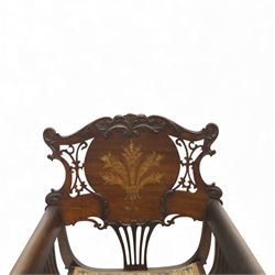 Art Nouveau mahogany open armchair in the manner of Shapland & Petter, the shaped and pierced back with foliate cresting and central panel inlaid with stylised marquetry plume, curved arms over upholstered seat, raised on sabre legs