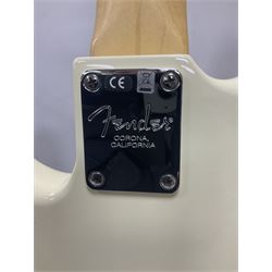 Fender Precision Bass guitar, in Olympic White finish with tortoiseshell effect scratchboard, serial no US15103092, in black Fender hard case with Fender strap and warranty card, guitar L116cm