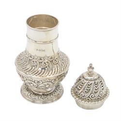 Late Victorian silver sugar caster, of typical waisted form, with embossed scrolling and foliate decoration and urn finial to removable pierced cover, upon circular foot, hallmarked Fenton Brothers, Sheffield 1895, H19cm