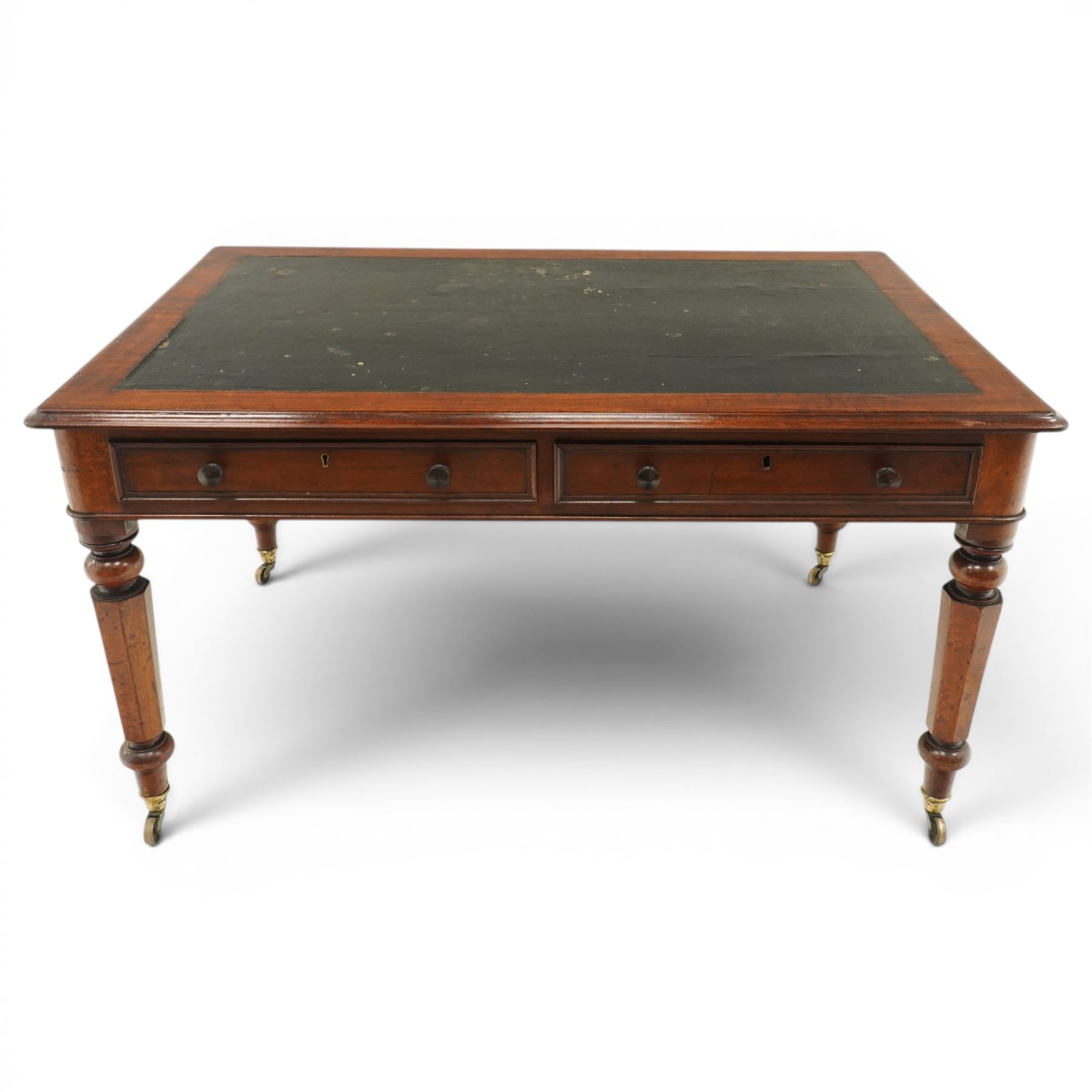 Mid Victorian four drawer mahogany partners' writing table, with leather inset top with moulded edge, with two frieze drawers to either side, on turned supports terminating in castors