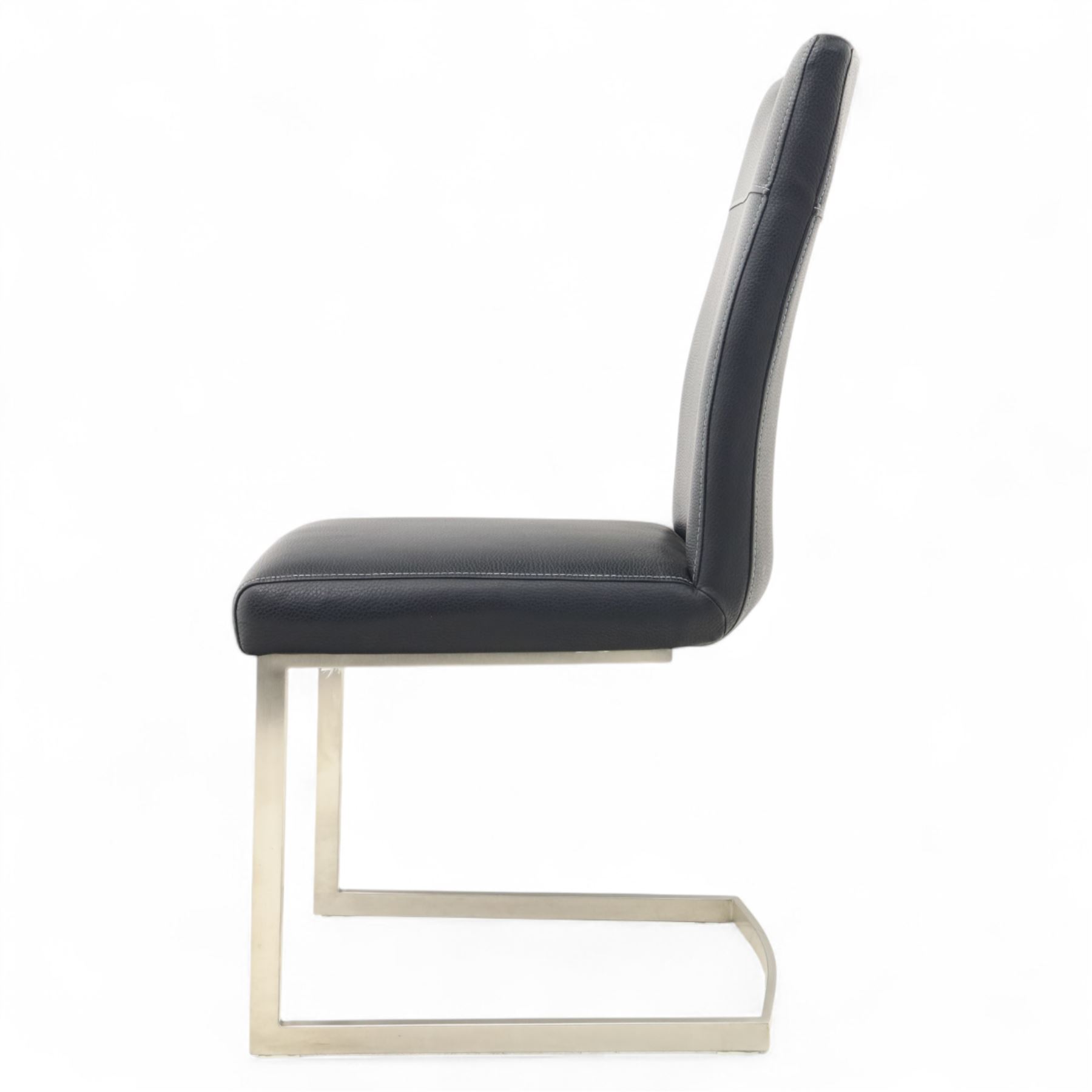 Set of seven contemporary style dining chairs, each with a high padded back and seat upholstered in faux leather on brushed steel sled bases  