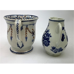 An 18th century Worcester blue and white sparrow beak jug, decorated with floral sprays, with crescent mark beneath, H10.5cm, together with a loving cup, H10.5cm. 